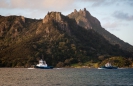 Tug boats returning to Marsden Point wharf with Mt Manaia across the harbour.
